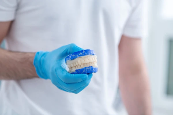 Custom dentures in the hands of a doctor
